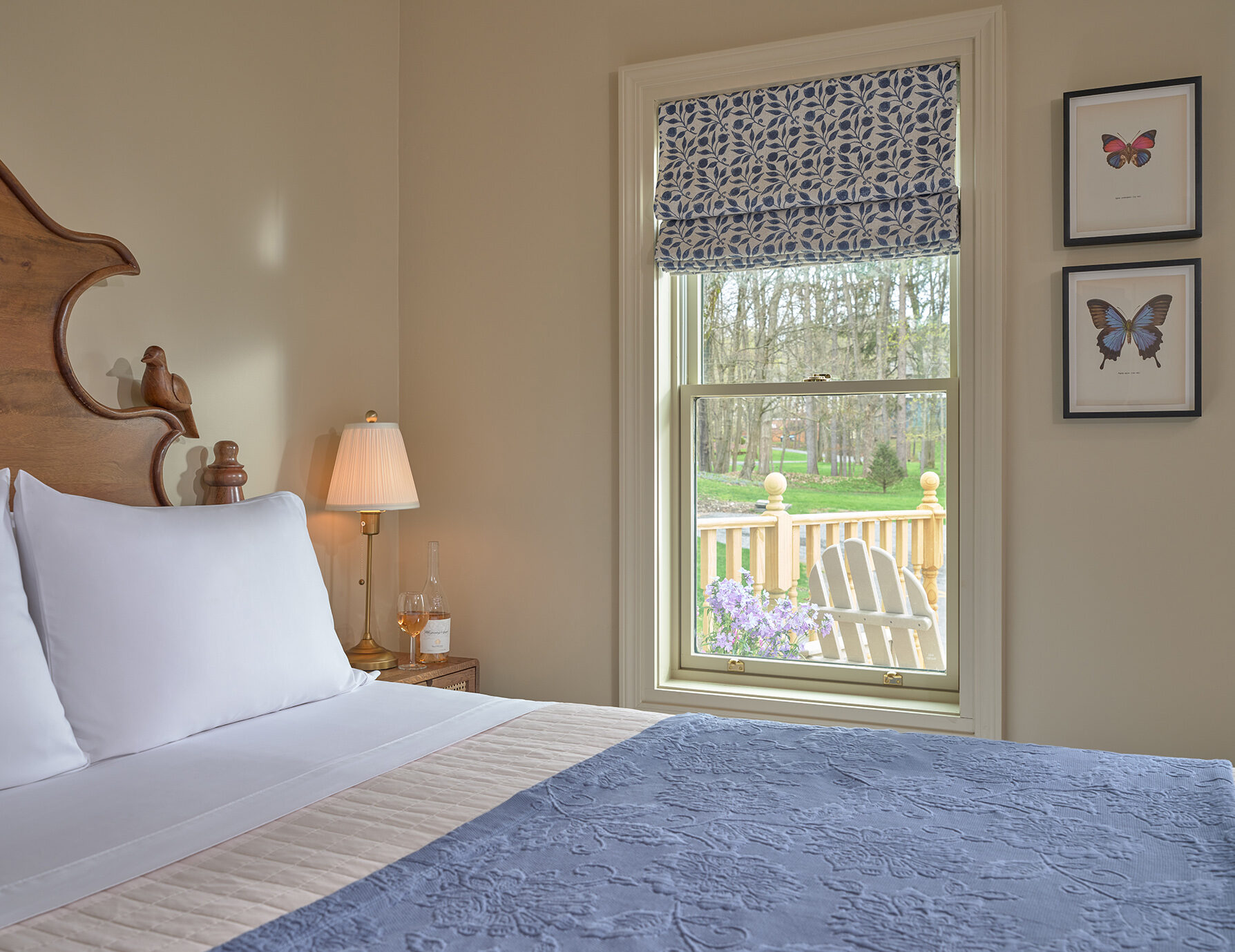 Ornate bed in the Petite Provence I Room next to glass exterior door