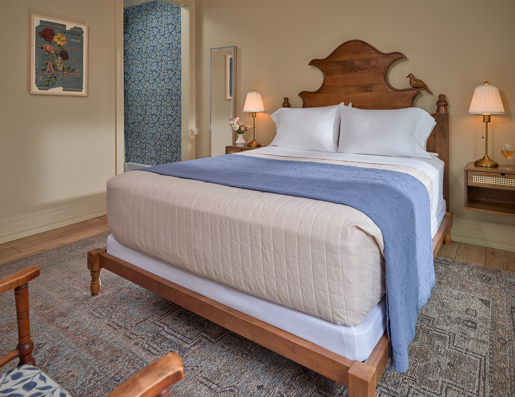 Comfortable, intricate bed in well-lit room at an Upstate NY B&B