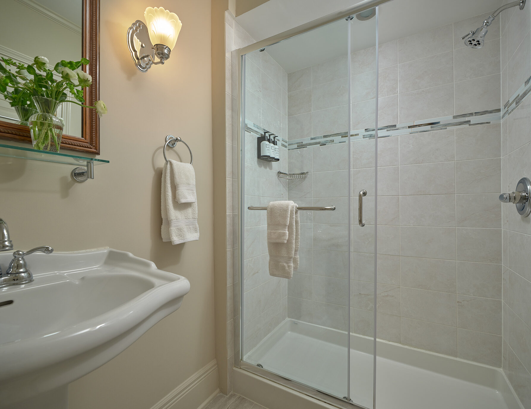 Pristine tile shower with bathrobe