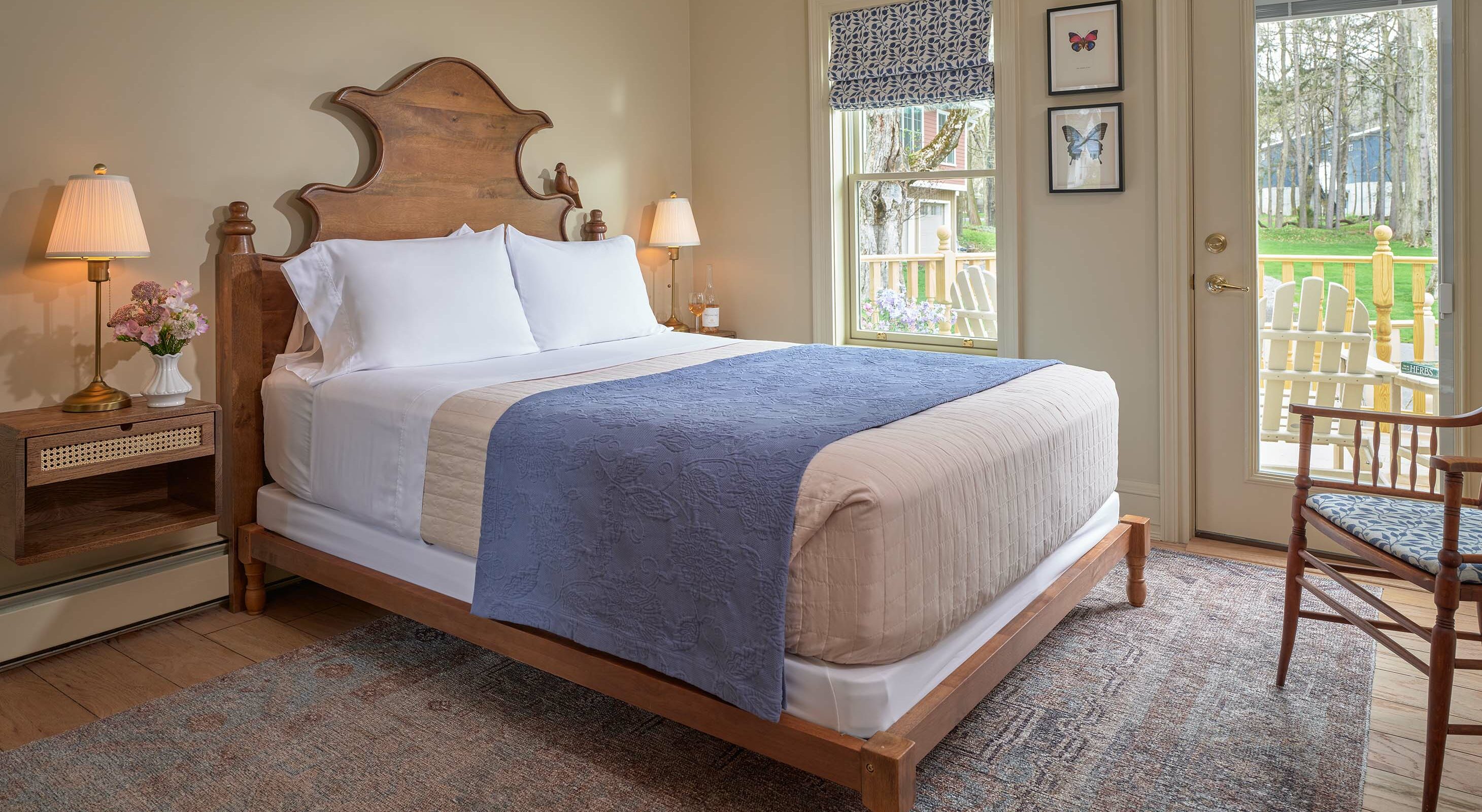 Ornate bed in the Petite Provence I Room next to glass exterior door